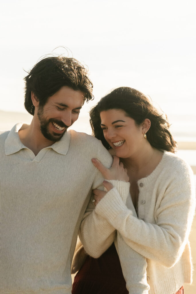 Couple smiling next to each other on the beach