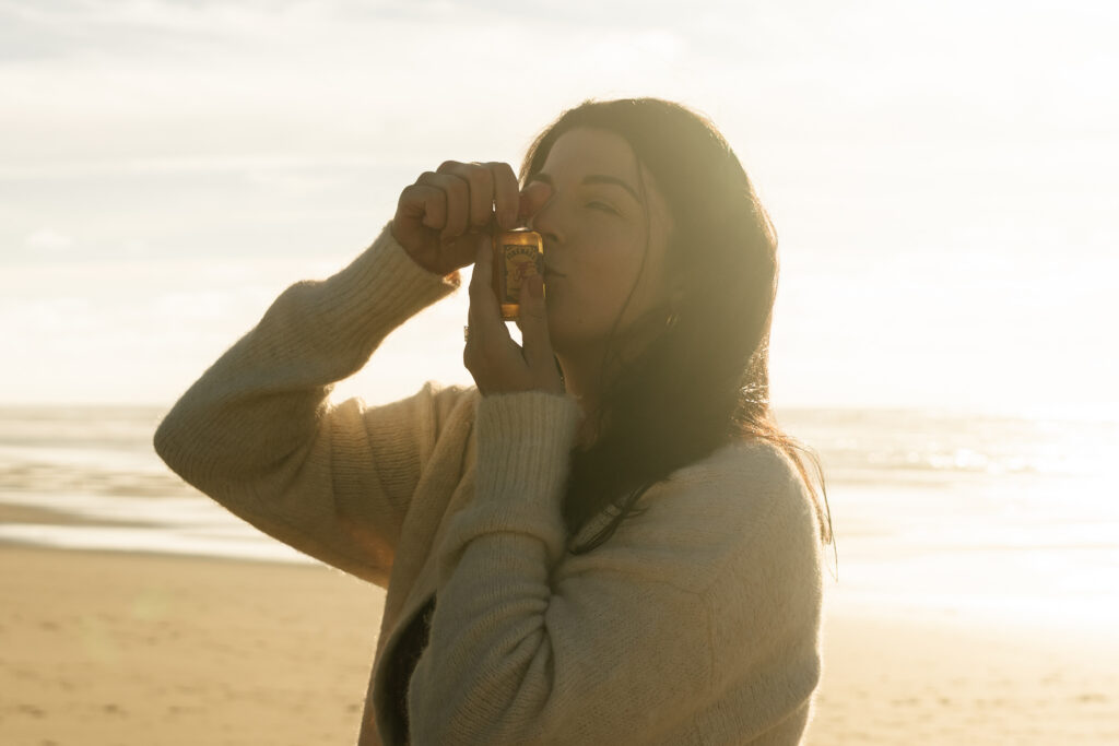 girl kissing her shot on the beach