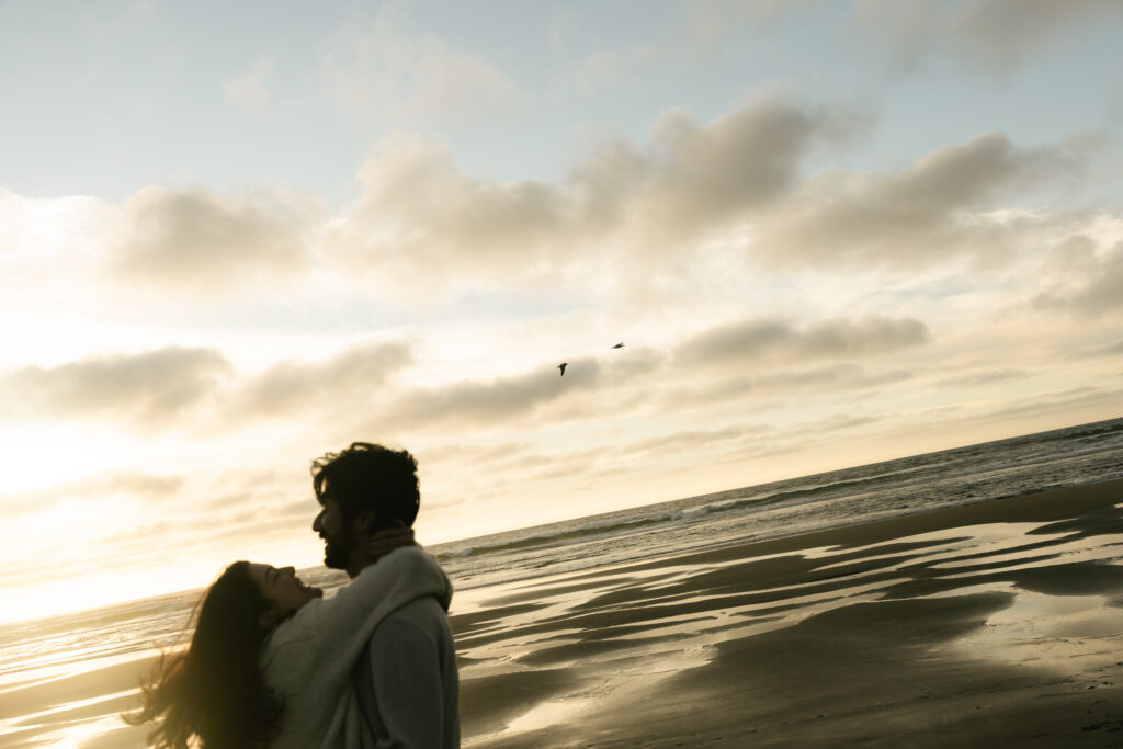 Man looking toward the ocean at sunset