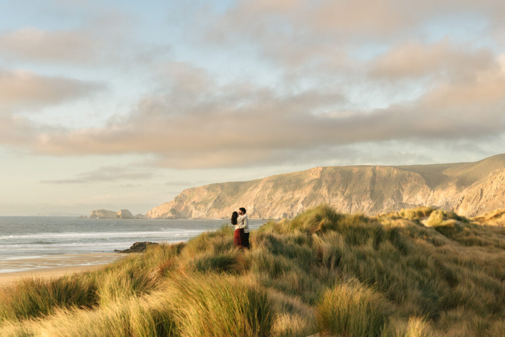 Coastal landscape with cliffs and ocean under soft pastel sky