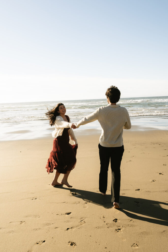 couple running together on the shoreline