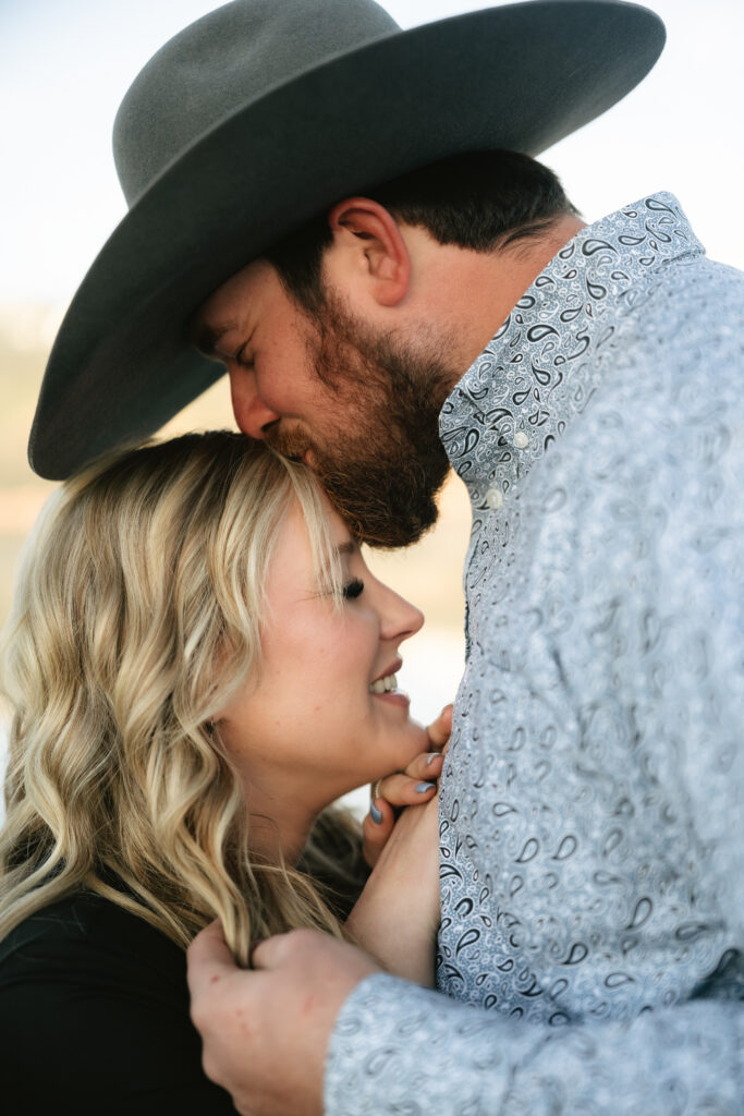 Man kissing womans forehead