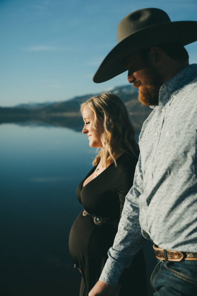 Film photo of man and woman holding hands and walking next to a lake